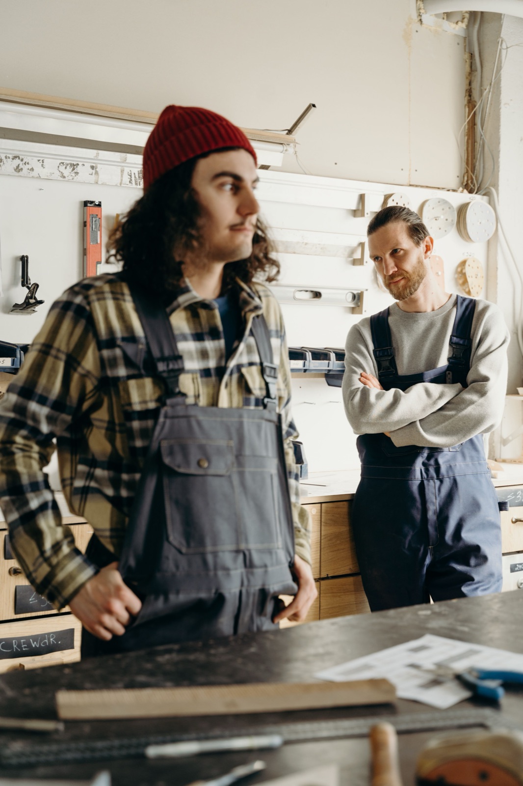 Two coworkers sharing an easy moment together in their workshop